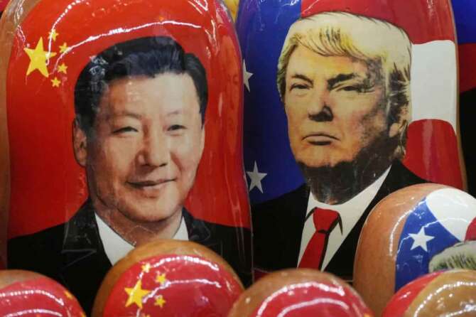 FILE – Traditional Russian wooden dolls called Matryoshka depicting China’s President Xi Jinping and President Donald Trump at a souvenir shop in St. Petersburg, Russia, Nov. 21, 2024. (AP Photo/Dmitri Lovetsky, File)