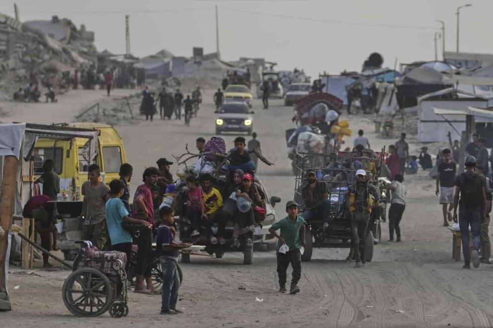 Displaced Palestinians travel on carts and vehicles through a makeshift camp along the beach in Gaza City, Sunday, Aug. 10, 2025. (AP Photo/Jehad Alshrafi)