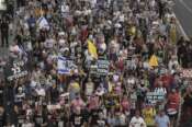 Relatives and supporters of hostages held by Hamas take part in a protest demanding their immediate release and calling for the end of the war in the Gaza Strip, as they march in Tel Aviv, Israel, Thursday, Aug. 21, 2025. (AP Photo/Mahmoud Illean)