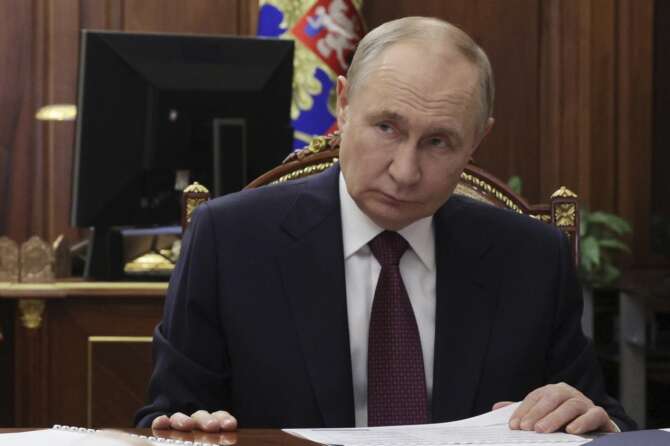 Russian President Vladimir Putin meets with Deputy Prime Minister, Chief of the Government Staff Dmitry Grigorenko at the Kremlin in Moscow, Russia, Monday, Aug. 25, 2025. (Vyacheslav Prokofyev, Sputnik, Kremlin Pool Photo via AP