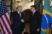 President Donald Trump shakes hands before a dinner with Brazilian President Jair Bolsonaro at Mar-a-Lago, Saturday, March 7, 2020, in Palm Beach, Fla. (AP Photo/Alex Brandon)