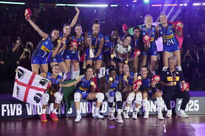 Italian players celebrate with their gold medal on podium after winning the FIVB Women’s Volleyball World Championship 2025 final match against Turkey at the Huamark Indoor Stadium, in Bangkok, Thailand, Sunday, Sept. 7, 2025. (AP Photo/Sakchai Lalit)
