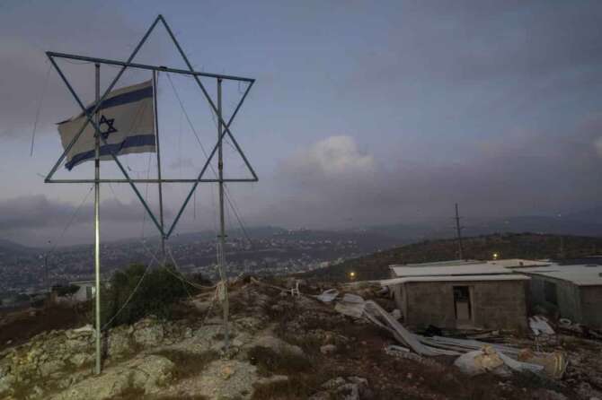 The Eviatar outpost is seen in the Israeli-occupied West Bank during morning prayers calling for the legalization of the outpost and the return of the hostages held in the Gaza Strip by the Hamas militant group, Sunday, July 7, 2024. Far-right ministers in Israel’s government have said they want to legalize unauthorized outposts in the West Bank in a sweeping expansion of settlements. (AP Photo/Ohad Zwigenberg)