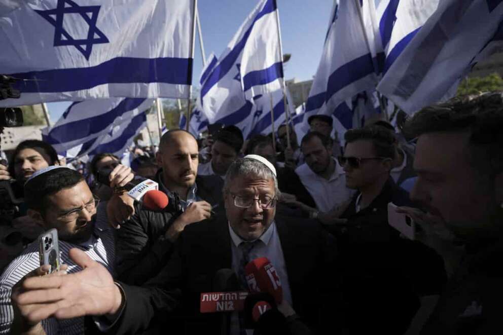 FILE – Israeli lawmaker Itamar Ben-Gvir, center, speaks to the media surrounded by right wing activists as they gather for a march in Jerusalem, April 20, 2022. Ben-Gvir visited Jerusalem’s most sensitive holy site Thursday, July 18, 2024, a move that could threaten the delicate Gaza cease-fire talks. (AP Photo/Ariel Schalit, File)