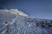 Oxygen cylinders are kept on a slope on the way to the summit of Mount Everest in Nepal, May 18, 2025. (AP Photo/Kunga Sherpa)