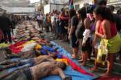 EDS NOTE: GRAPHIC CONTENT – Residents look at the bodies of people killed the day before during a police raid targeting the Comando Vermelho gang at the Complexo da Penha favela in Rio de Janeiro, Brazil, Wednesday, Oct. 29, 2025. (AP Photo/Silvia Izquierdo)