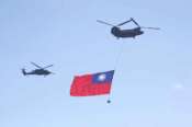 A helicopter flies over the President Office with a national flag during National Day celebrations in front of the Presidential Building in Taipei, Taiwan, Friday, Oct. 10, 2025. (AP Photo/Chiang Ying-ying)