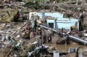 Residents try to salvage personal belongings as they return to their damaged homes after Typhoon Kalmaegi caused devastation in communities along the Mananga River in Talisay City, Cebu province, central Philippines, Wednesday, Nov. 5, 2025. (AP Photo/Jacqueline Hernandez)