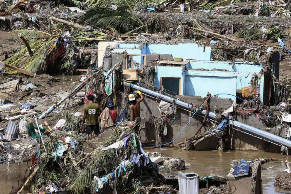 Residents try to salvage personal belongings as they return to their damaged homes after Typhoon Kalmaegi caused devastation in communities along the Mananga River in Talisay City, Cebu province, central Philippines, Wednesday, Nov. 5, 2025. (AP Photo/Jacqueline Hernandez)