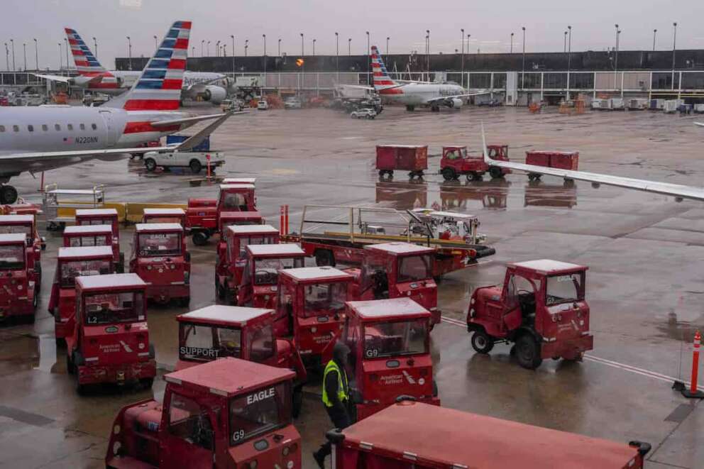 A worker stands on the tarmac amidst American Airlines planes at Chicago O’Hare International Airport in Chicago, Ill., Sunday, Nov. 9, 2025. (AP Photo/Adam Gray)