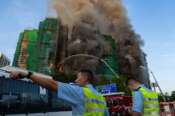 First responders work the scene of a fire at Wang Fuk Court, a residential estate in the Tai Po district of Hong Kong’s New Territories on Wednesday, Nov. 26 2025. (AP Photo/Chan Long Hei)