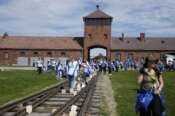 People walk through the former Nazi German death camp of Auschwitz-Birkenau as they attend the annual Holocaust remembrance event, the “March of the Living” in memory of the six million Holocaust victims in Oswiecim, Poland, Monday, May 6, 2024. The event comes amid the dramatic backdrop of the violence of the Israel-Hamas war after the Oct. 7 Hamas attack, the deadliest violence against Jews since the Holocaust, and as pro-Palestinian protests sweep U.S. campuses. (AP Photo/Czarek Sokolowski) associated Press / LaPresse Only italy and spain