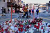 A skier passes candles near the sealed off Le Constellation bar in Crans-Montana, Swiss Alps, Switzerland, Saturday, Jan. 3, 2026, where a devastating fire left dead and injured during the New Year’s celebrations. (AP Photo/Baz Ratner)
