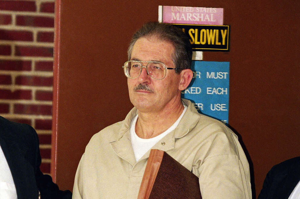 FILE – Former CIA agent Aldrich Ames leaves federal court after pleading guilty to espionage and tax evasion conspiracy charges April 28, 1994, in Alexandria, Va. (AP Photo/Wilfredo Lee, File)