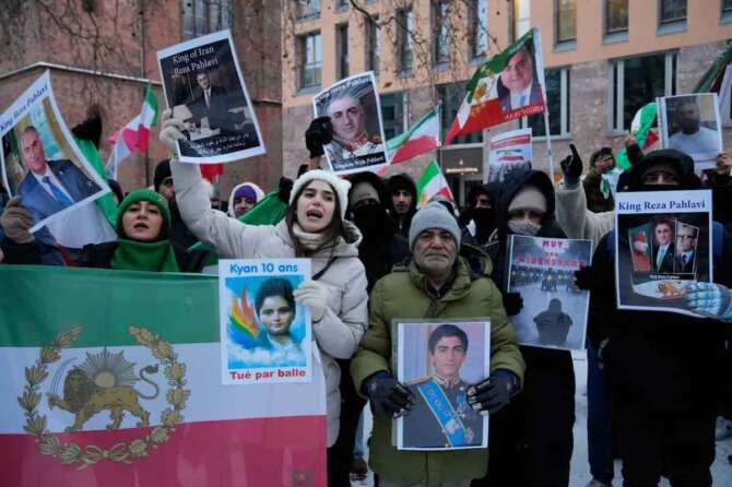 Protesters showing pictured of Reza Pahlavi, Crown Prince of Iran, at a demonstration in Berlin, Germany, in support of the nationwide mass protests in Iran against the government, Friday, Jan. 9, 2026. (AP Photo/Ebrahim Noroozi)