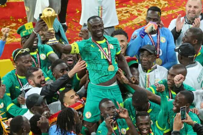 Senegal’s Sadio Mane holds the trophy aloft as he celebrates with teammates after winning the Africa Cup of Nations final soccer match between Senegal and Morocco in Rabat, Morocco, Sunday, Jan. 18, 2026. (AP Photo/Youssef Loulidi)