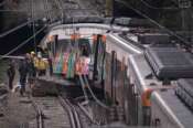 Police officers inspect the damage after a commuter train derailed as a retaining wall collapsed onto the tracks in Gelida, near Barcelona, Spain, Wednesday, Jan. 21, 2026. (AP Photo/Joan Mateu Parra) Associate Press/ LaPresse Only Italy and Spain