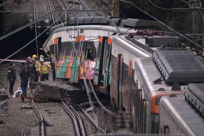 Police officers inspect the damage after a commuter train derailed as a retaining wall collapsed onto the tracks in Gelida, near Barcelona, Spain, Wednesday, Jan. 21, 2026. (AP Photo/Joan Mateu Parra) Associate Press/ LaPresse Only Italy and Spain