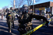 Federal agents stand near the site of a shooting Saturday, Jan. 24, 2026, in Minneapolis. (AP Photo/Abbie Parr)