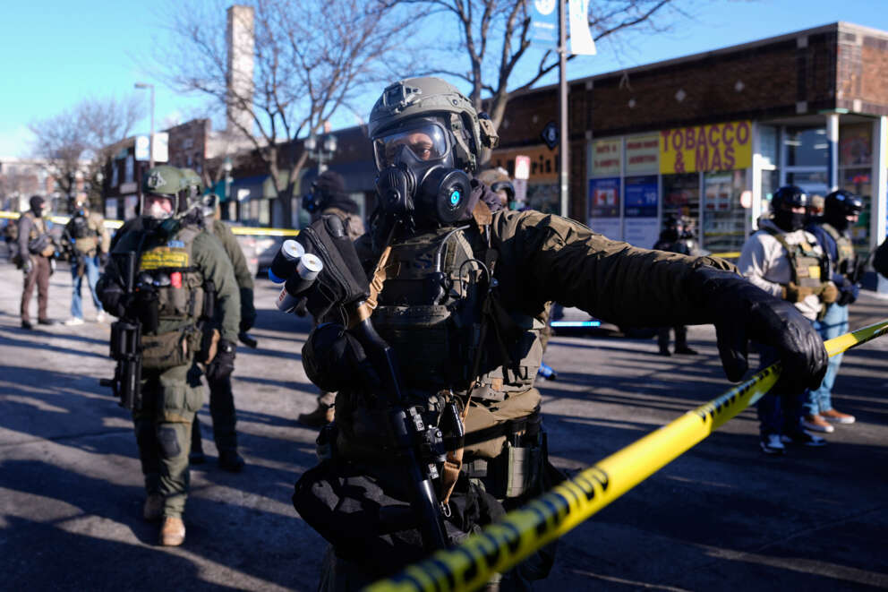 Federal agents stand near the site of a shooting Saturday, Jan. 24, 2026, in Minneapolis. (AP Photo/Abbie Parr)