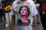 An activist wearing a T-shirt with the image of former city councilwoman Marielle Franco attends a rally prior to the trial for Franco’s alleged killers, outside the Court of Justice, in Rio de Janeiro, Wednesday, Oct. 30, 2024. (AP Photo/Silvia Izquierdo) Associated Press/LaPresse