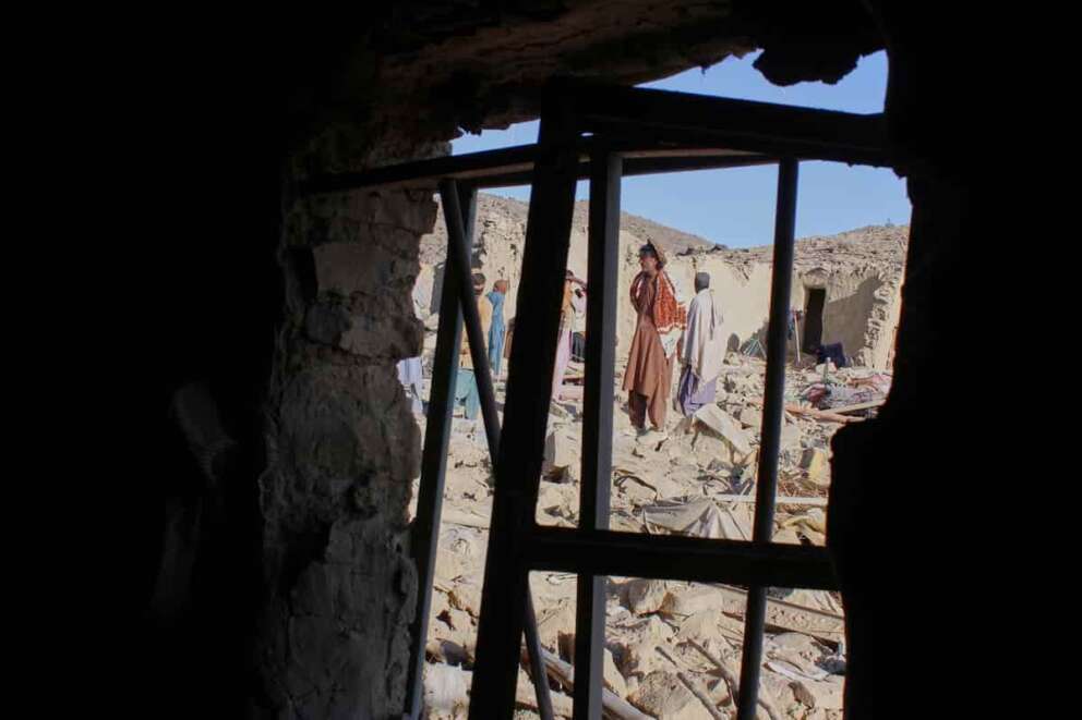 Afghan men search through the rubble at the site of an overnight attack on a home that, according to an Afghan government spokesman, was carried out by Pakistan, in the Gurbaz district of Khost province, Afghanistan, Tuesday, Nov. 25, 2025. (AP Photo/Saifullah Zahir)