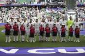 Team Iran stands for their national anthem before the Asian Cup quarterfinal soccer match between Japan and Iran at Education City Stadium in Al Rayyan, Qatar, Saturday, Feb. 3, 2024. (AP Photo/Aijaz Rahi)