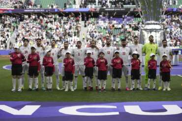 Team Iran stands for their national anthem before the Asian Cup quarterfinal soccer match between Japan and Iran at Education City Stadium in Al Rayyan, Qatar, Saturday, Feb. 3, 2024. (AP Photo/Aijaz Rahi)