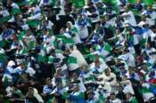 Supporters of Uzbekistan national soccer team cheer prior to a World Cup 2026 group A qualifying soccer match between Iran and Uzbekistan at Azadi Stadium in Tehran, Iran, Tuesday, March 25, 2025. (AP Photo/Vahid Salemi)