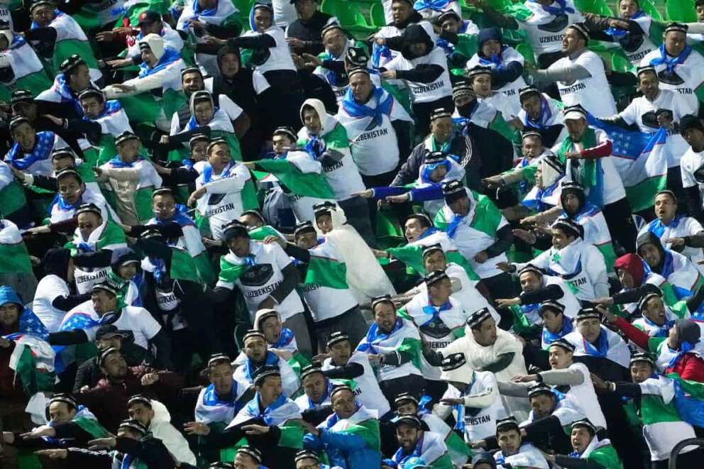 Supporters of Uzbekistan national soccer team cheer prior to a World Cup 2026 group A qualifying soccer match between Iran and Uzbekistan at Azadi Stadium in Tehran, Iran, Tuesday, March 25, 2025. (AP Photo/Vahid Salemi)