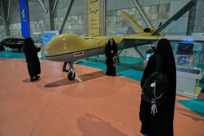 People take picture with Shahed-129 Iranian domestically-built drone as they visit the National Aerospace Park of the Revolutionary Guard, just outside Tehran, Iran, Thursday, Nov. 13, 2025. (AP Photo/Vahid Salemi)