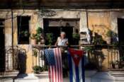 FILE – Javier Yanez stands on his balcony where he hung a U.S. and Cuban flag in Old Havana Cuba, Friday, Dec. 19, 2014. (AP Photo/Ramon Espinosa, File) Associate Press/ LaPresse Only Italy and Spain