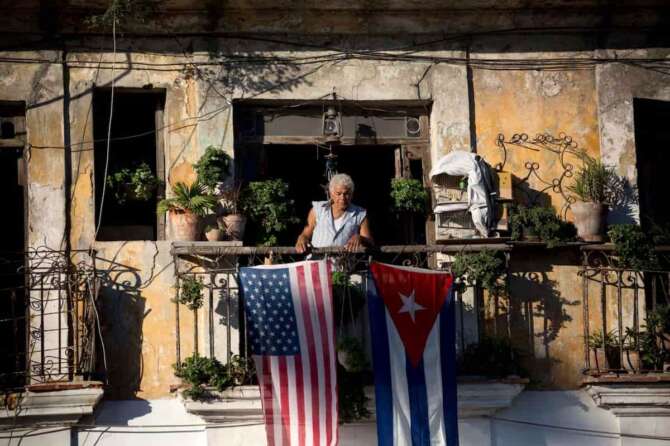 FILE – Javier Yanez stands on his balcony where he hung a U.S. and Cuban flag in Old Havana Cuba, Friday, Dec. 19, 2014. (AP Photo/Ramon Espinosa, File) Associate Press/ LaPresse Only Italy and Spain