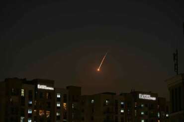 The flare of a projectile is seen over the skyline of Dubai, United Arab Emirates, Saturday, Feb. 28, 2026. (AP Photo/Fatima Shbair)