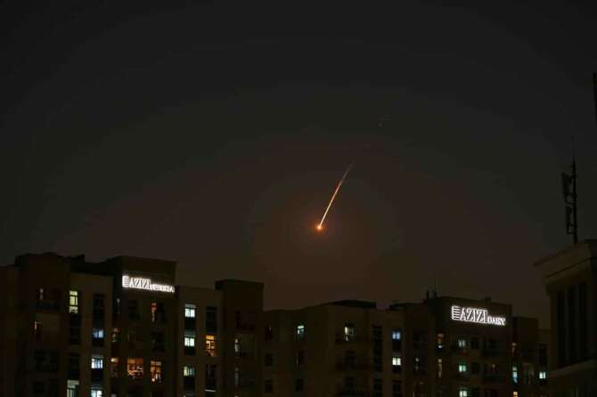 The flare of a projectile is seen over the skyline of Dubai, United Arab Emirates, Saturday, Feb. 28, 2026. (AP Photo/Fatima Shbair)