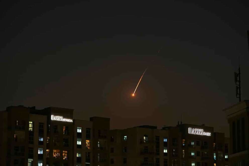 The flare of a projectile is seen over the skyline of Dubai, United Arab Emirates, Saturday, Feb. 28, 2026. (AP Photo/Fatima Shbair)