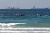 FILE – Fishermen work in front of oil tankers south of the Strait of Hormuz Jan. 19, 2012, offshore the town of Ras Al Khaimah in United Arab Emirates. (AP Photo/Kamran Jebreili, File)