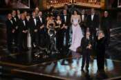 Paul Thomas Anderson, left center, Sara Murphy, right center, and the team from “One Battle After Another” accept the award for best picture during the Oscars on Sunday, March 15, 2026, at the Dolby Theatre in Los Angeles. (AP Photo/Chris Pizzello)