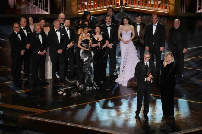 Paul Thomas Anderson, left center, Sara Murphy, right center, and the team from “One Battle After Another” accept the award for best picture during the Oscars on Sunday, March 15, 2026, at the Dolby Theatre in Los Angeles. (AP Photo/Chris Pizzello)