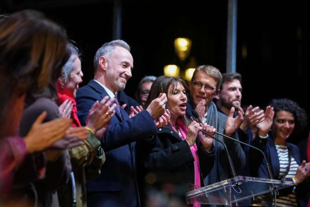 French socialist candidate for Paris mayoral election Emmanuel Gregoire, center left, and, Anne Hidalgo, center right, give a speech after Gregoire won the second round of France’s municipal elections in Paris, Sunday, March 22, 2026. (AP Photo/Thibault Camus)