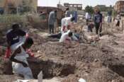 Members of the Sudanese Red Crescent rebury the remains of victims of Sudan’s two-year conflict, transferring bodies from makeshift graves to a local cemetery in Khartoum, Sudan, Sunday, Jan. 11, 2026. (AP Photo/Marwan Ali)