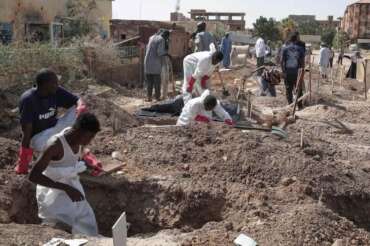 Members of the Sudanese Red Crescent rebury the remains of victims of Sudan’s two-year conflict, transferring bodies from makeshift graves to a local cemetery in Khartoum, Sudan, Sunday, Jan. 11, 2026. (AP Photo/Marwan Ali)