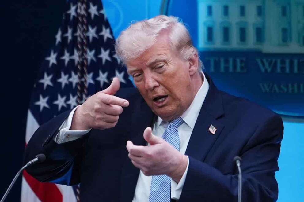 President Donald Trump pretends to aim a sniper gun while speaking with reporters in the James Brady Press Briefing Room at the White House, Monday, April 6, 2026, in Washington. (AP Photo/Julia Demaree Nikhinson)