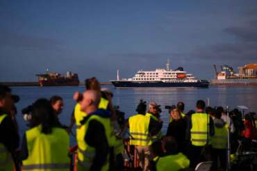 Media and emergency services personnel work next the hantavirus-stricken cruise ship MV Hondius after its arrival at the port of Granadilla in Tenerife, Canary Islands, Spain, Sunday, May 10, 2026. (AP Photo/Manu Fernandez)
