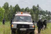 Congolese police provide security for Red Cross workers during a burial for an Ebola victim at the Rwampara Cemetery, in Bunia, Congo, Saturday, May 23, 2026. (AP Photo/Moses Sawasawa)