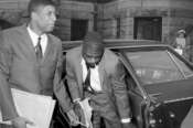 FILE – Co-defendants, from left, John Artis and Rubin “Hurricane” Carter, right, arrive at Pasaic County Courthouse Annex in Paterson, N.J., May 25, 1967. Artis, who was wrongly convicted with boxer Carter in a triple murder case that was publicized in a 1975 song by Bob Dylan and a 1999 film starring Denzel Washington, has died, Artis died at 75 on Nov. 7, 2021 of a gastric aneurysm at his home in Hampton, Va., said Fred Hogan, a longtime friend who who worked to help overturn the convictions of Artis and Carter. (AP Photo/Anthony Camerano, File)