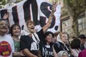 Taty Almeida, of the Mothers of Plaza de Mayo human rights group, waves during a march marking the 48th anniversary of the military coup in Buenos Aires, Argentina, Sunday, March 24, 2024. (AP Photo/Victor R. Caivano)