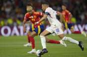France’s Kylian Mbappe, front, controls a ball challenged by Spain’s Lamine Yamal during the Nations League semifinal soccer match between Spain and France at the MHPArena, in Stuttgart, Germany, Thursday, June 5, 2025. (AP Photo/Martin Meissner)