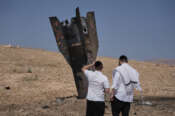 People inspect the wreckage of an Iranian missile that landed near the West Bank city of Jericho Monday, June 8, 2026. (AP Photo/Mahmoud Illean)