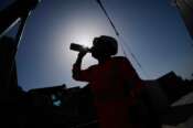 A worker drinks water on a construction site during high temperatures in Boulogne Billancourt, outside Paris, Wednesday, June 24, 2026. (AP Photo/Christophe Ena ) Associate Press/ LaPresse Only Italy and Spain